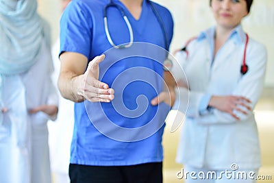 Friendly male doctor with open hand ready for hugging Stock Photo