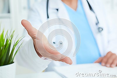 Friendly male doctor with open hand ready for hugging closeup. Stock Photo