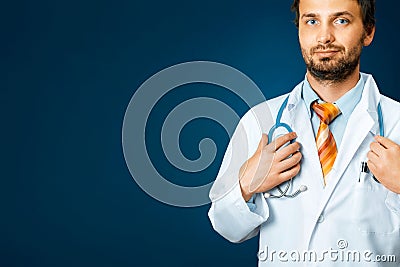 Friendly Male Doctor In White Coat Holds Hand On Stethoscope. People Care Medicine Insurance Concept Stock Photo