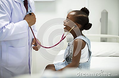 Friendly pediatrician entertaining his patient Stock Photo