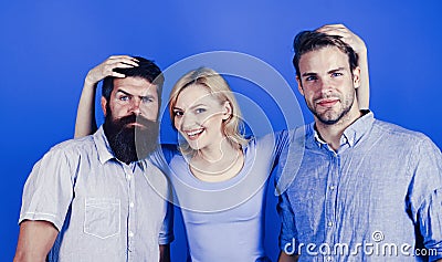 Friendly relations. Girl and guys happy together. Woman hugs two men. More than friends. True friendship and human Stock Photo