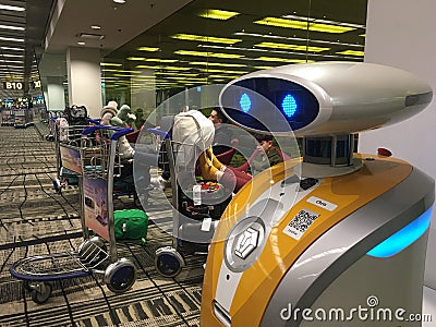 Friendly robot and Changi Airport Singapore Editorial Stock Photo