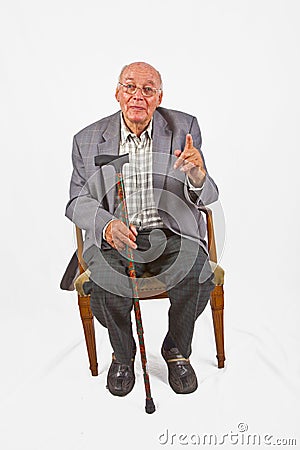 Friendly senior man sitting in his chair Stock Photo