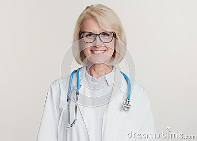 Friendly senior woman doctor is smiling. Isolated Stock Photo