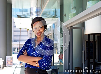 Friendly smiling business woman standing outside in the city Stock Photo