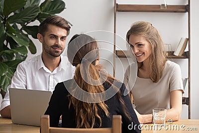 Friendly smiling partners meeting female client or job candidate Stock Photo