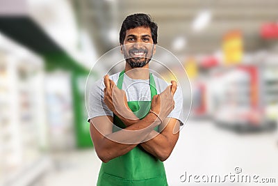 Supermarket worker making good luck gesture Stock Photo