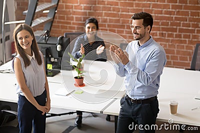 Friendly team leader, boss introducing hired new member of team Stock Photo