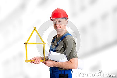 Friendly worker with yardstick- house and blueprint Stock Photo