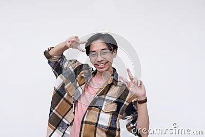 A friendly young asian man making two peace signs while smiling. Isolated on a white background Stock Photo