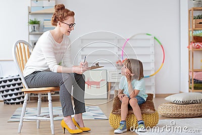 Psychologist talking with little boy Stock Photo