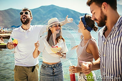 Friends at the beach drinking cocktails having fun on summer vacatio Stock Photo