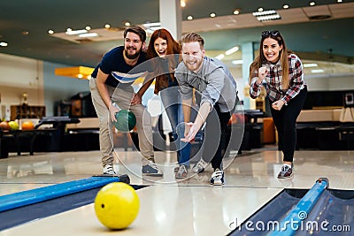 Friends bowling at club Stock Photo