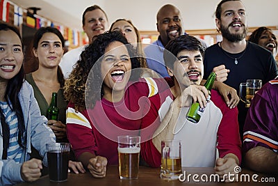 Friends cheering sport at bar together Stock Photo