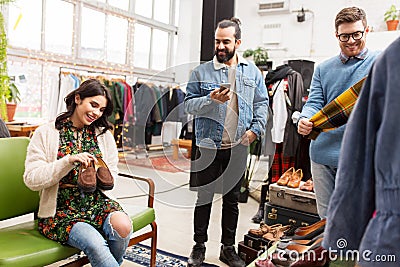 Friends choosing clothes at vintage clothing store Stock Photo