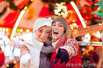 Friends during the Christmas market or advent season Stock Photo