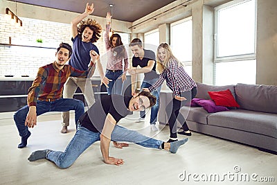 Friends dance at a student`s party in the apartment. Stock Photo