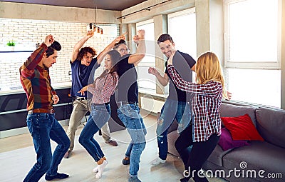 Friends dance at a student`s party in the apartment. Stock Photo