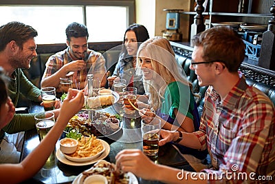 Friends dining and drinking beer at restaurant Stock Photo