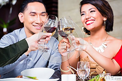 Friends dining in fancy restaurant Stock Photo