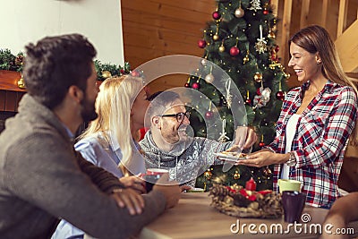 Friends drinking coffee and eating cookies on Christmas morning Stock Photo