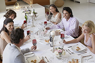 Friends Drinking And Socialising At Dinner Party Stock Photo