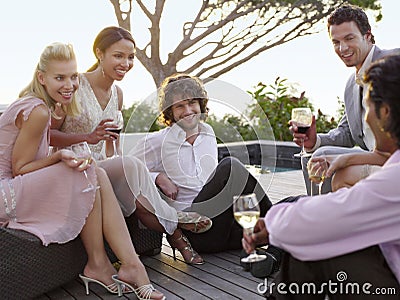 Friends Drinking And Socialising On Porch Stock Photo