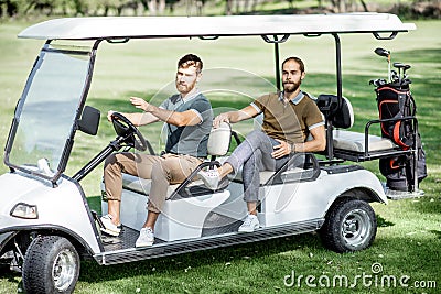 Friends driving golf car Stock Photo