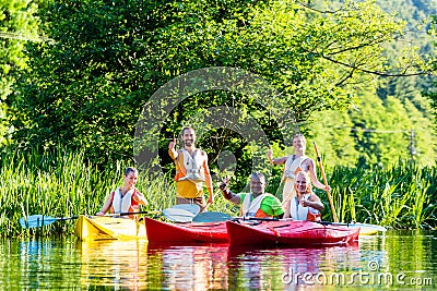 Friends driving with kayak on river Stock Photo