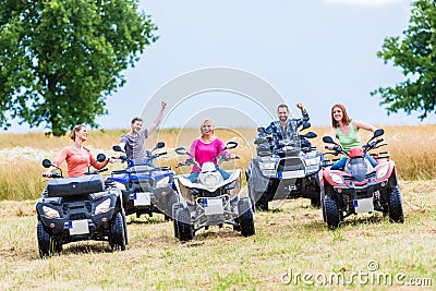 Friends driving off-road with quad bike Stock Photo