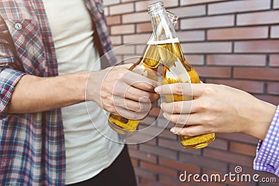 Couple of young friends having fun with beer at street Stock Photo