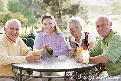 Friends Enjoying A Beverage By A Golf Course Stock Photo