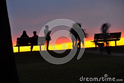 Friends Excite at Deep Sunset Light Stock Photo