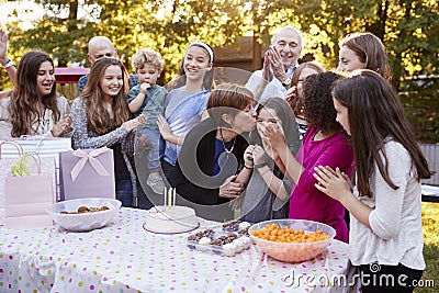 Friends and family gathered at a garden birthday party Stock Photo