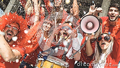 Friends football supporter fans cheering with confetti watching Stock Photo