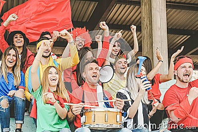 Friends football supporter fans watching soccer match event at stadium - Young people group having fun celebrating Stock Photo