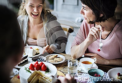 Friends Gathering Together on Tea Party Eating Cakes Enjoyment h Stock Photo