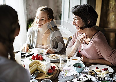 Friends Gathering Together on Tea Party Eating Cakes Enjoyment h Stock Photo