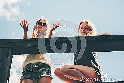 Friends girls walking together happy smiling talking Stock Photo