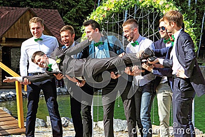 Groom portraying superhero flying to bride Stock Photo