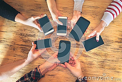Friends group having fun together using smartphones - Hands detail sharing content on social network with mobile smart phone Stock Photo