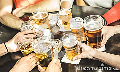 Friends hands drinking beer at brewery pub restaurant - Friendship concept with young people enjoying time together and having ge Stock Photo