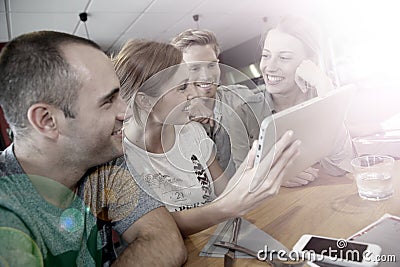 Friends having fun on campus with tablet Stock Photo