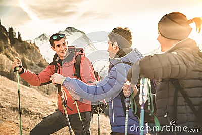 Friends hikers group trekking on french alps mountain at sunset Stock Photo