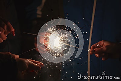 Friends holding beautiful sparklers in celebration of the new year Stock Photo