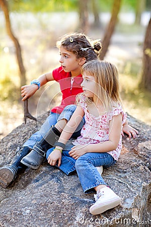 Friends kid girls playing in forest rock Stock Photo