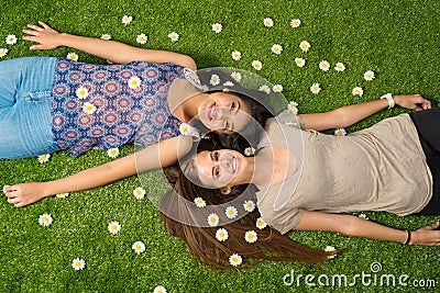 Friends Laying In The Grass Stock Photo