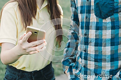 Friends looking at mobile phone outdoors Stock Photo