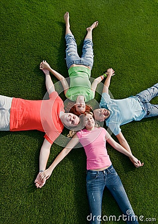 Friends lying on grass Stock Photo