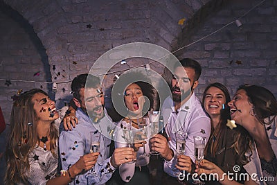 Friends making a toast for New Year`s Eve midnight countdown Stock Photo